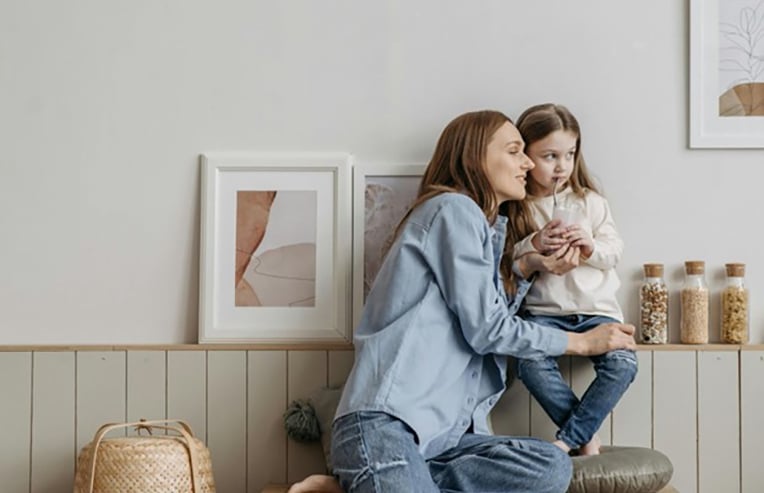 a mother teaching her young daughter how to heal from PMS and period pain