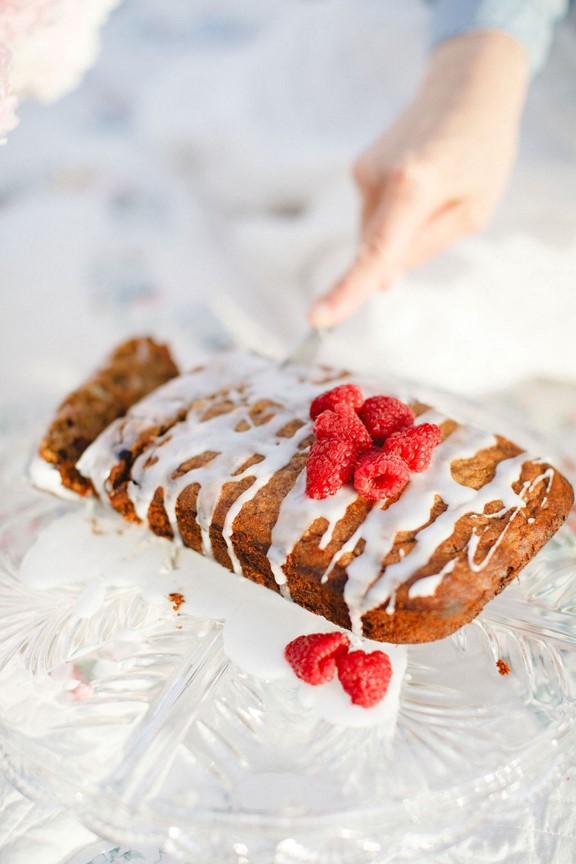 A person cutting a loaf of bread with raspberries learning a comprehensive approach to PCOS phenotypes