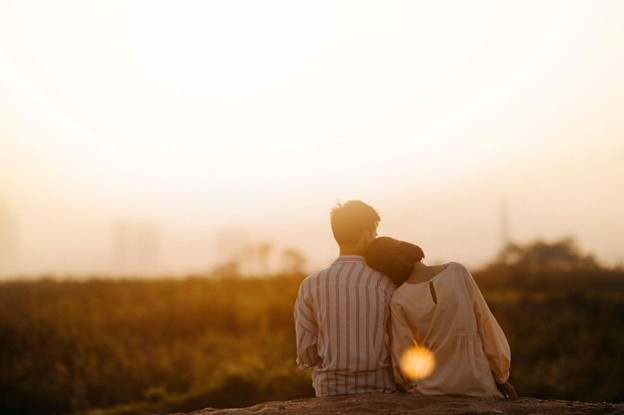 A man and woman sitting on a rock at dusk with luteal phase deficiency