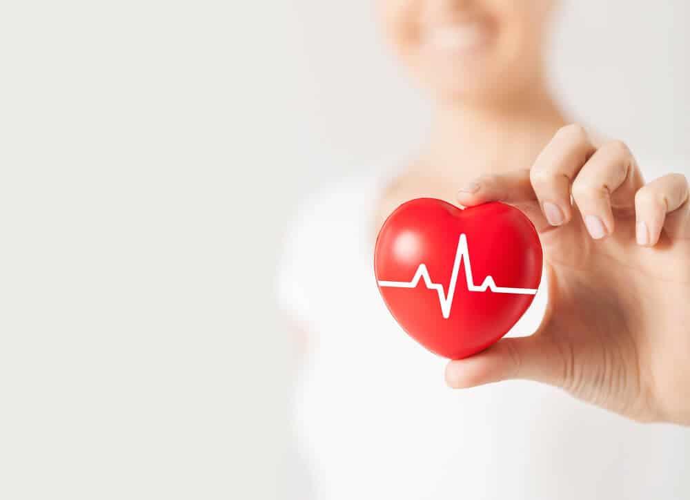 hand holding heart shaped ball for cardiovascular effects of PCOS