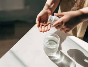 Woman dispensing vitamins into her hand